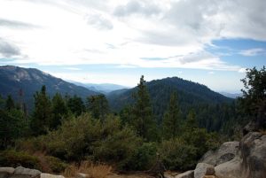 A stunning vista of the mountains in Ben Lomond, California, captured from a rocky outcrop, highlighting the region's beauty.