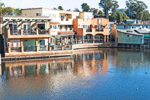 A peaceful vista of a water body in Capitola, California, mirroring the bright blue sky and the nearby coastal landscape.