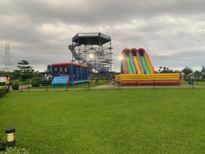 A large inflatable slide and a bouncy castle set up at Pleasure Point, California, inviting children to play and enjoy.