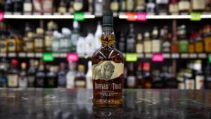 A bottle of whiskey elegantly placed on a polished bar in Scotts Valley, California, showcasing its rich amber color.